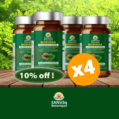 Four bottles of SANUSq Health Moringa supplement with a 10% off label on a wooden surface with greenery in the background.